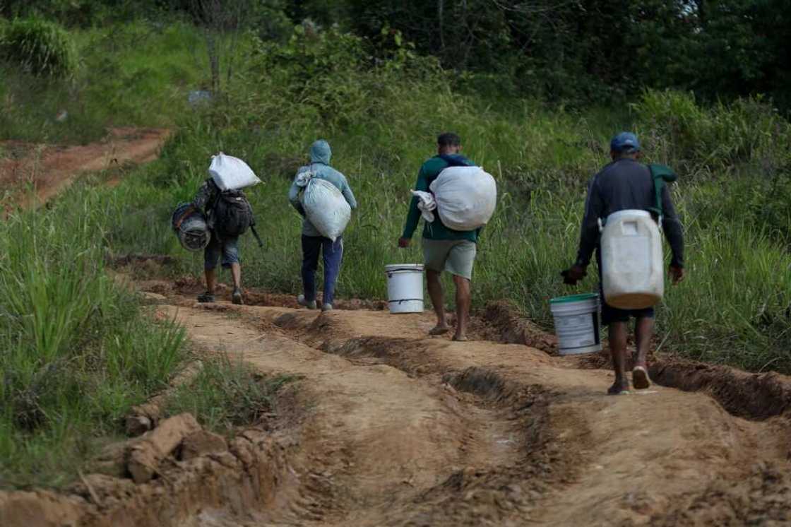 Alleged illegal miners leave a mining area inside Yanomami indigenous land Alleged illegal miners leave a mining area inside Yanomami indigenous land