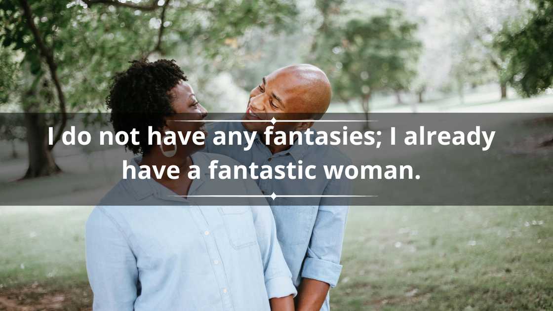 A couple in matching blue shirts is happily looking into each other's eyes A couple in matching blue shirts is happily looking into each other's eyes