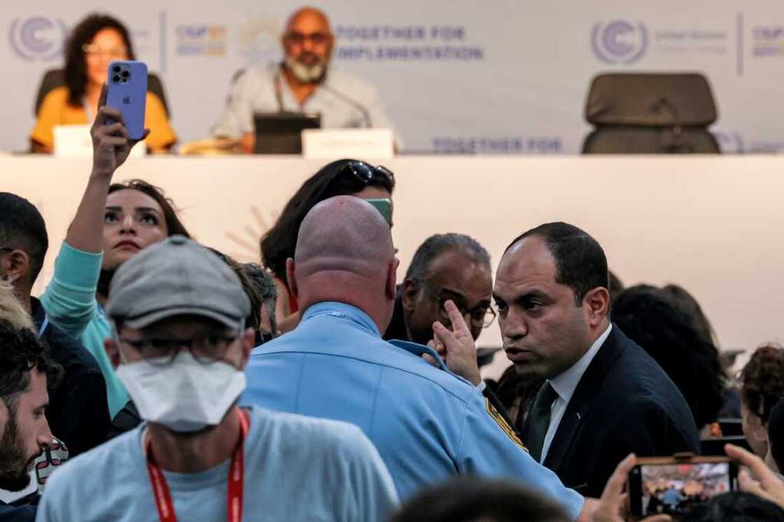 Egyptian MP Amr Darwish is escorted out by United Nations security during a press conference hosted by the Global Campaign to Demand Climate Justice and attended by Sanaa Seif, sister of imprisoned British-Egyptian activist Alaa Abdel Fattah