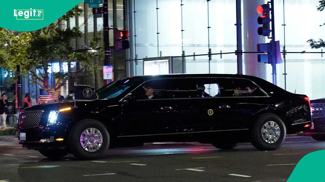 National Guard members stand guard inside a building as attendees are allowed to leave but not permitted to re-enter, while tight security is maintained outside.