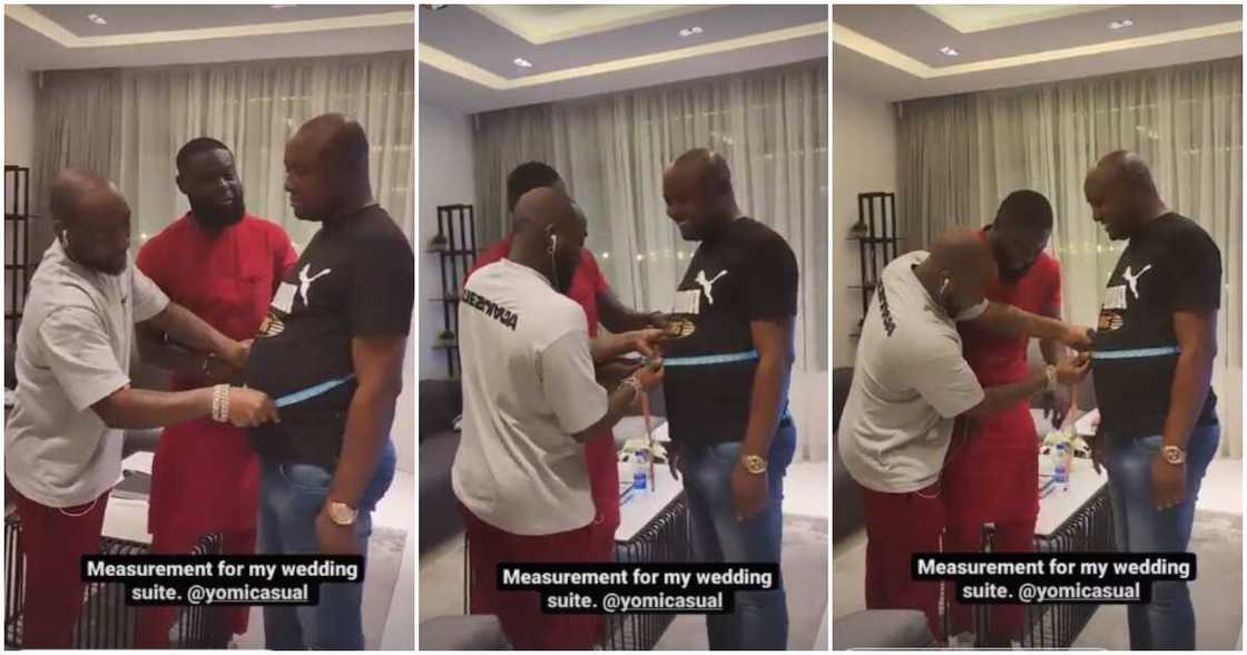 Davido helps Isreal take his wedding suit measurment.