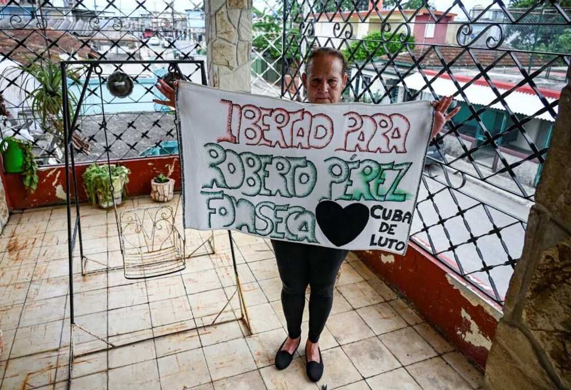 Liset Fonseca, mother of Roberto Perez Fonseca, also detained in the 2021 protests, shows a poster demanding the release of her son Liset Fonseca, mother of Roberto Perez Fonseca, also detained in the 2021 protests, shows a poster demanding the release of her son
