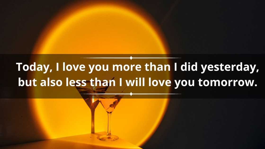 Creative image of a martini cocktail glass on an orange neon light in a nightclub bar Creative image of a martini cocktail glass on an orange neon light in a nightclub bar