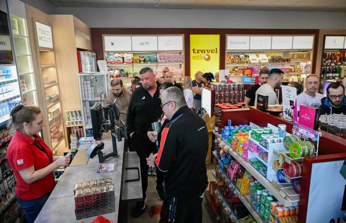 Romanian tourists line up to shop for goods at a supermarket in Rousse Romanian tourists line up to shop for goods at a supermarket in Rousse