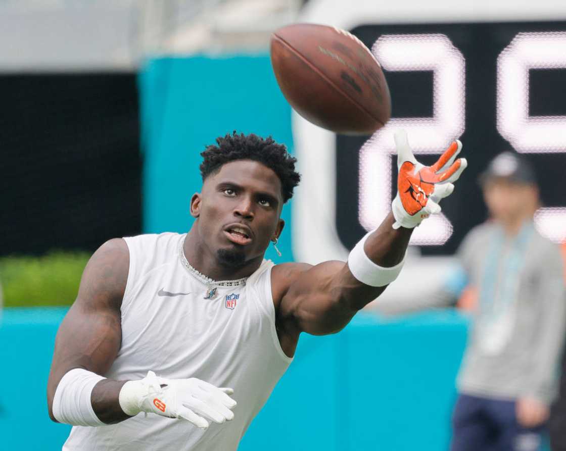 Dolphins receiver Tyreek Hill catches a ball before a game against the Washington Commanders