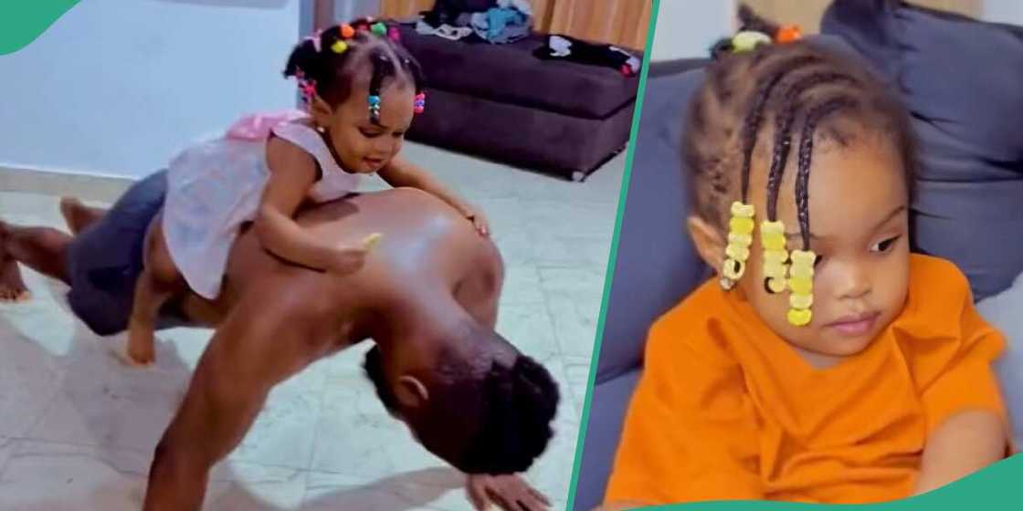 Little girl stays on man's back as he works out. Little girl stays on man's back as he works out.