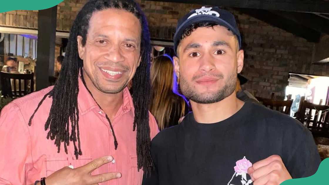 Charles Latibeaudiere shares a moment with a friend