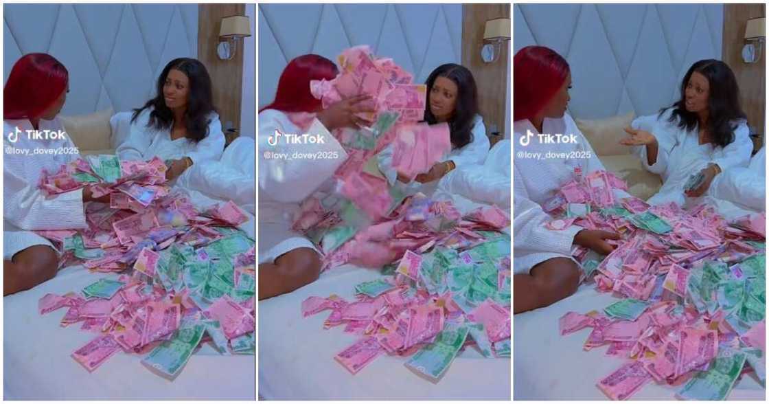 Two ladies play in bed with new naira notes