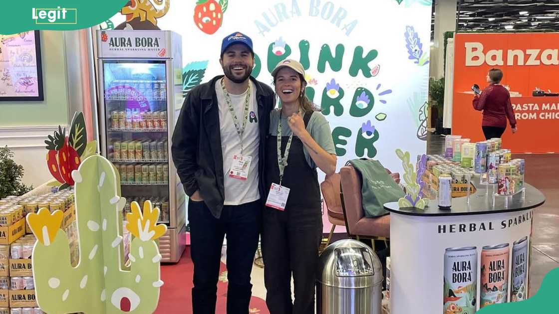 CEO Paul Voje and a lady pose for a photo at a retail shop