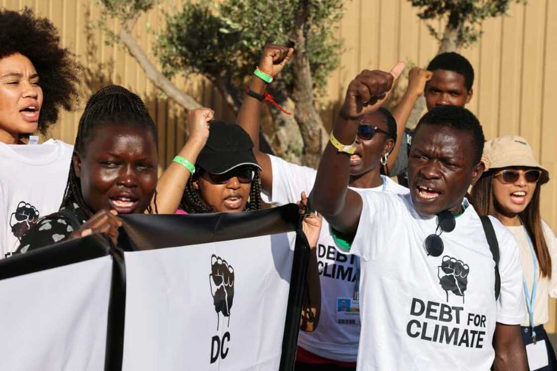 Activists lift banners as they stage a protest during the COP27 climate conference in the Egyptian Red Sea resort of Sharm el-Sheikh Activists lift banners as they stage a protest during the COP27 climate conference in the Egyptian Red Sea resort of Sharm el-Sheikh
