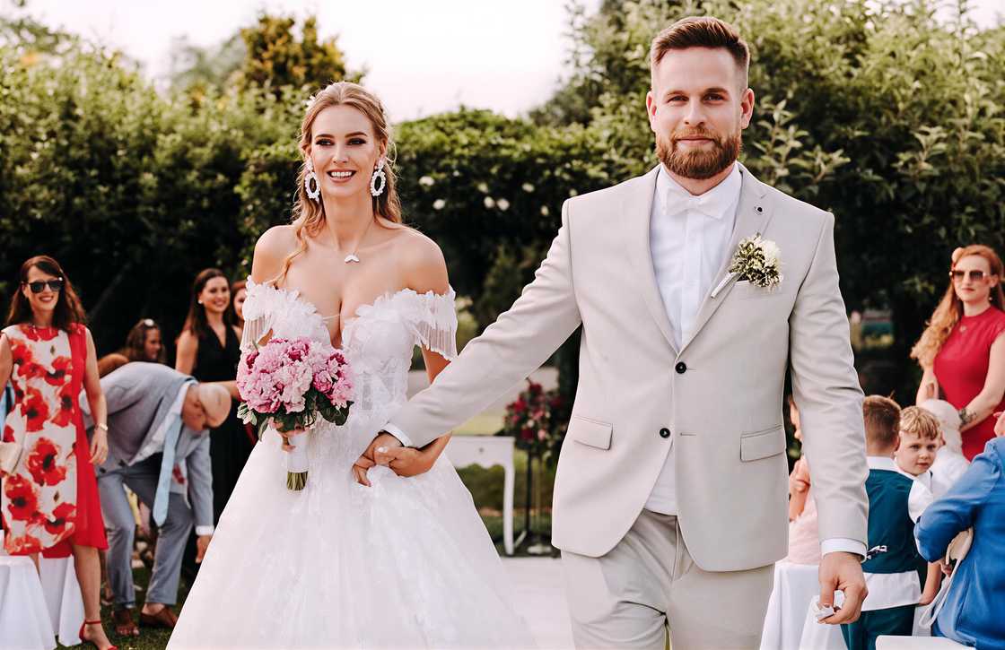 Veronika and her husband, Victor Rajek, walk hand in hand during their wedding. Veronika and her husband, Victor Rajek, walk hand in hand during their wedding.