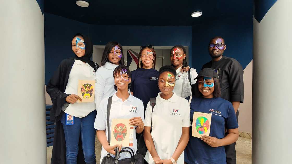 Miva students posing for a photo with booklets and painted faces Miva students posing for a photo with booklets and painted faces