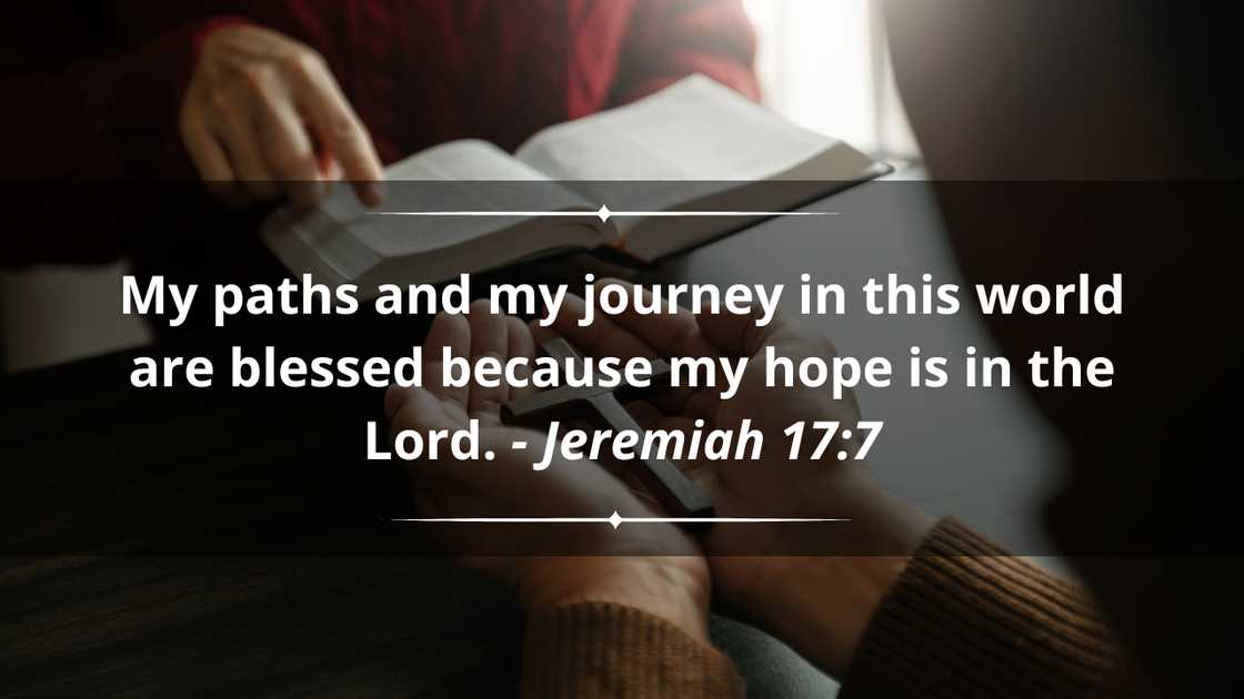 Two people reading and studying the Bible at home and praying together.