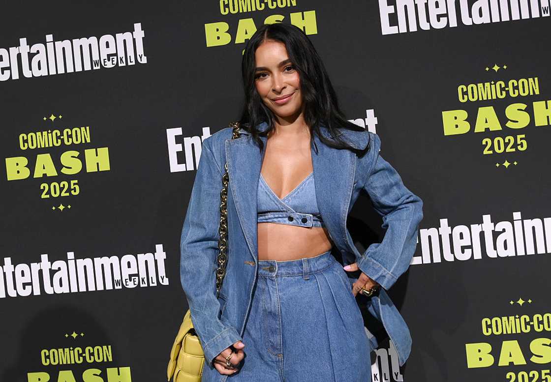 Jessica Caban poses on a media step-and-repeat backdrop for "Comic-Con Bash 2025"