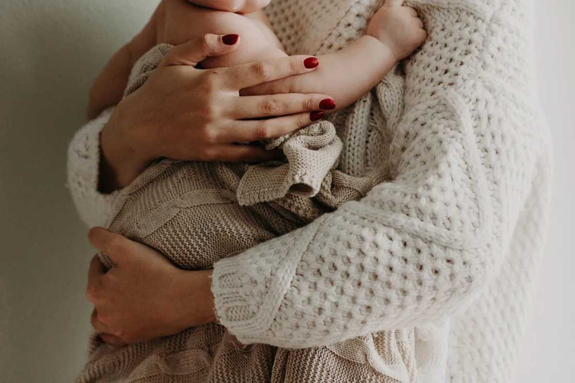 Mom holds newborn Mom holds newborn