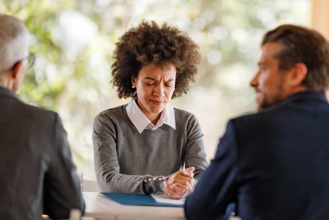 A summoned woman in the boardroom