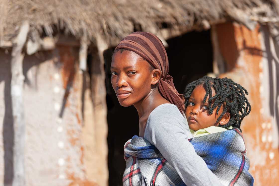 A woman carrying her child A woman carrying her child