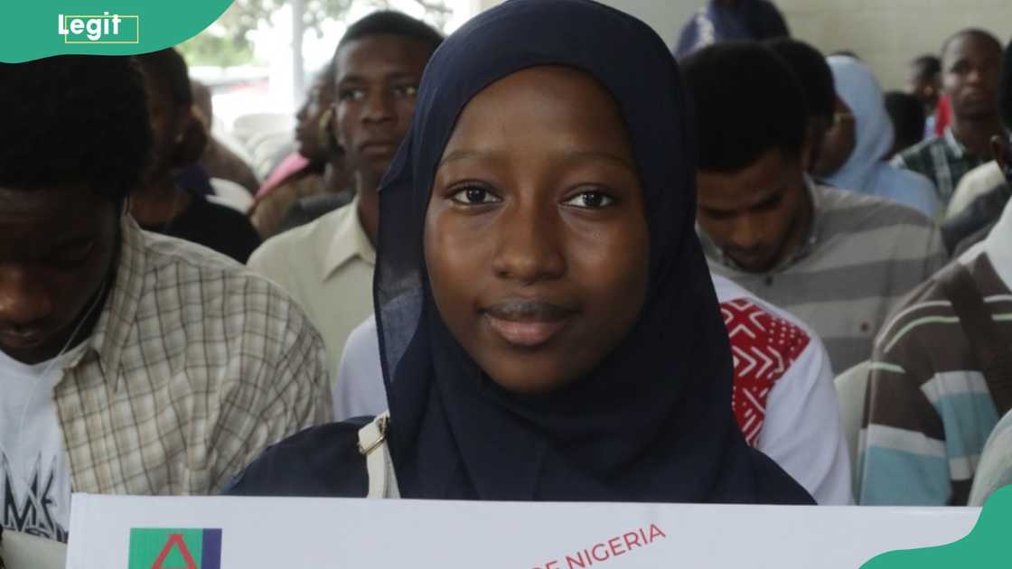 A young lady carries a banner during freshman orientation at the American University of Nigeria