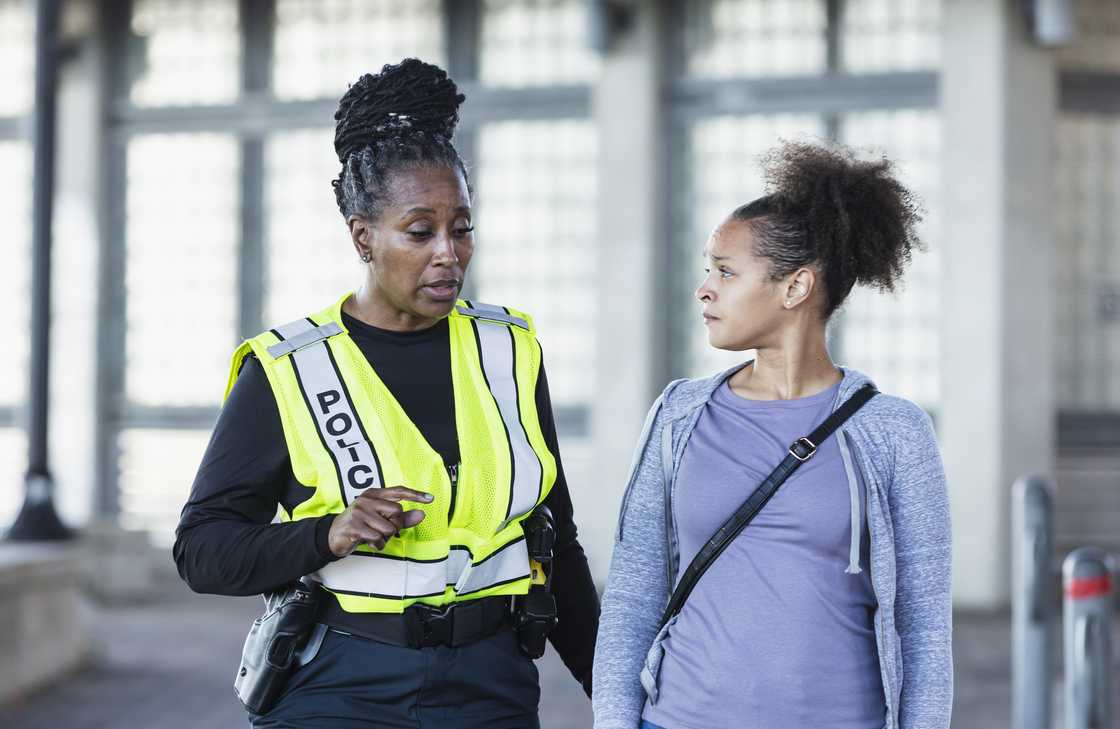 A police woman talking with young woman A police woman talking with young woman