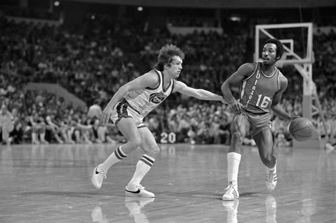 Monte Towe (L) tackles an opponent during past NBA game