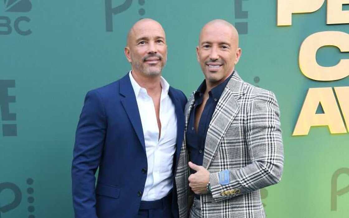 Brett Oppenheim in a navy blue coat and white shirt (L) and Jason Oppenheim in a checked coat and navy blue shirt (R)