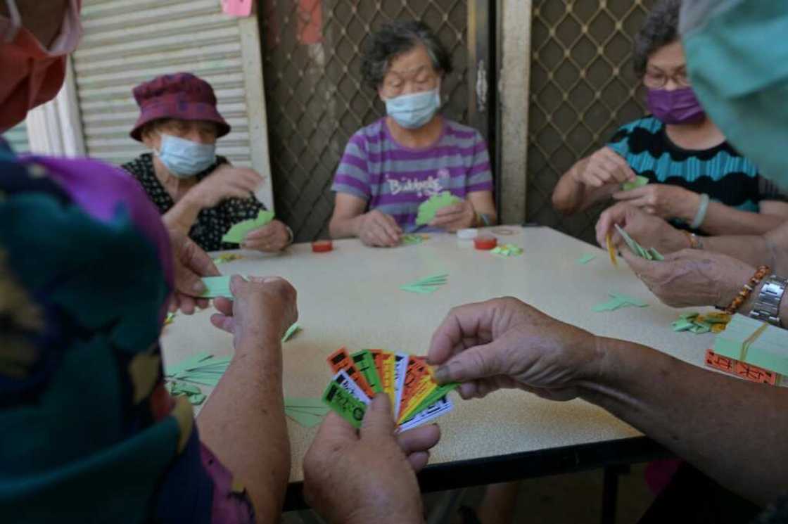 Senior residents play cards on a quiet street in the Kinmen Islands