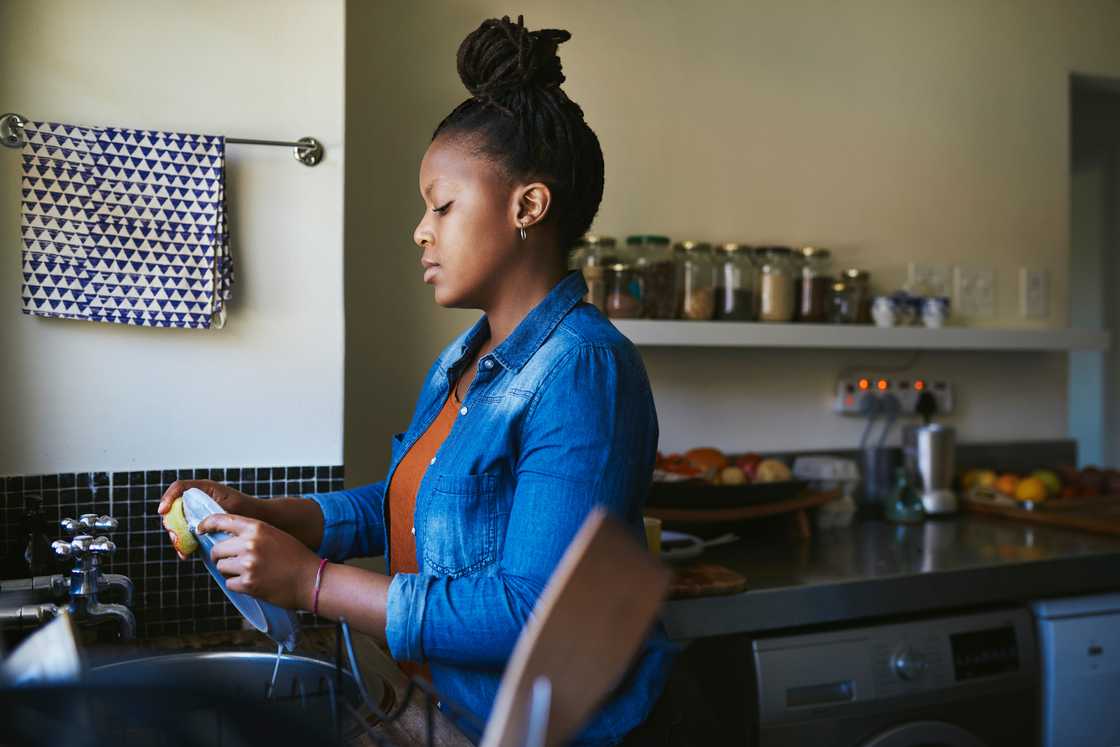A woman washes dishes