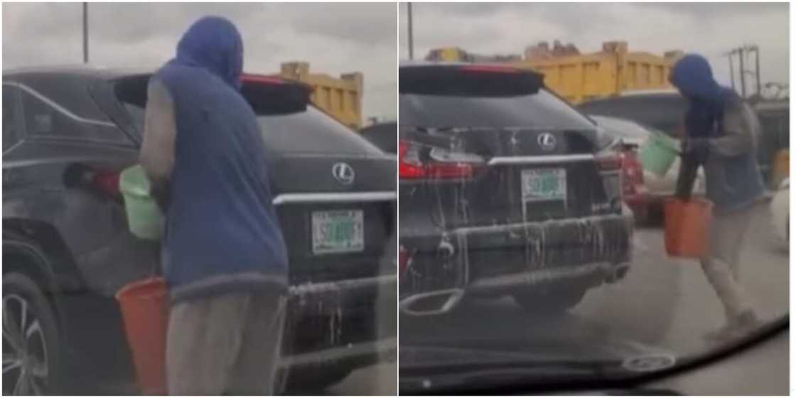 Man washing car in traffic Man washing car in traffic