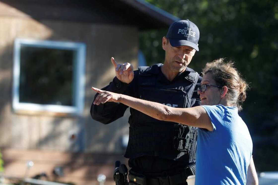 Ruby Works, a friend of a victim, speaks to a Royal Canadian Mounted Police officer in Weldon, Saskatchewan after the stabbing spree Ruby Works, a friend of a victim, speaks to a Royal Canadian Mounted Police officer in Weldon, Saskatchewan after the stabbing spree