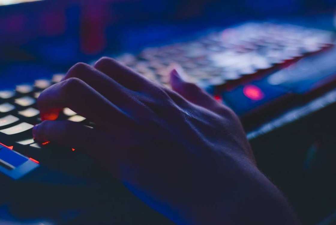 A person typing on a computer keyboard