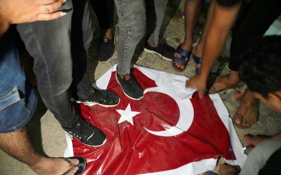 Iraqi protesters trample on a Turkish flag outside the consulate in the Shiite shrine city of Najaf, angry at the deaths of nine people in what the government says was Turkish shelling of a Kurdish hill village Iraqi protesters trample on a Turkish flag outside the consulate in the Shiite shrine city of Najaf, angry at the deaths of nine people in what the government says was Turkish shelling of a Kurdish hill village