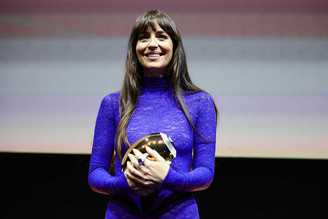 Dakota Johnson accepts the Golden Eye Award during the "Splitsville" award ceremony