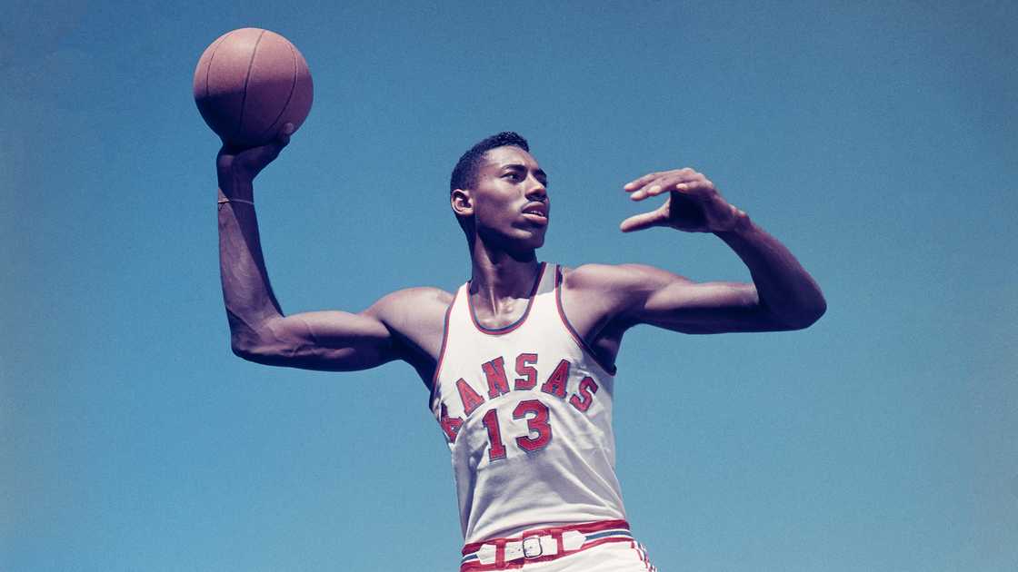 Wilt Chamberlain of the University of Kansas holds a basketball while posing for a portrait. Wilt Chamberlain of the University of Kansas holds a basketball while posing for a portrait.