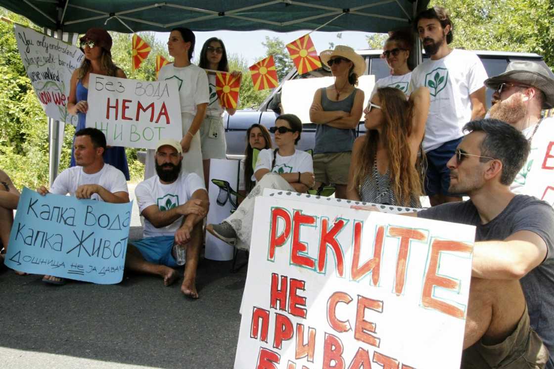 Environmental activist hold a banner reading "Rivers are not private business" as they gather to protest the construction of small hydropower plants on the Dosnica river Environmental activist hold a banner reading "Rivers are not private business" as they gather to protest the construction of small hydropower plants on the Dosnica river