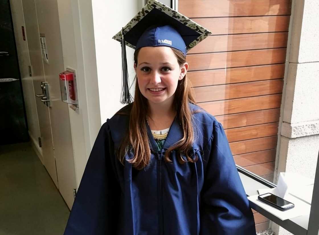 Madison Marilla poses in a graduation gown and cap Madison Marilla poses in a graduation gown and cap