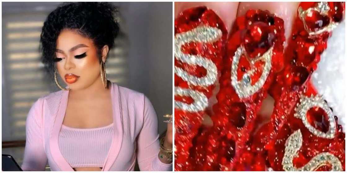 Photos of crossdresser Bobrisky shows and his Valentine nails. Photos of crossdresser Bobrisky shows and his Valentine nails.