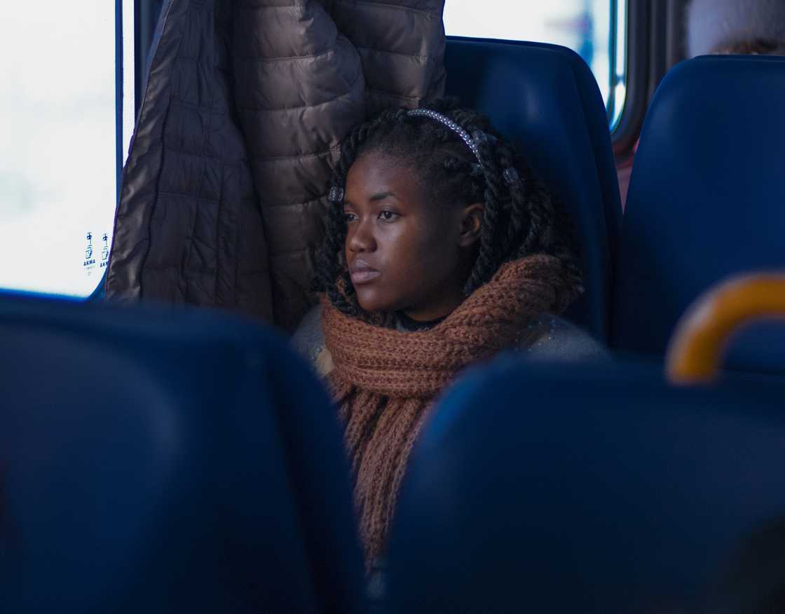 A distressed woman sitting on a train