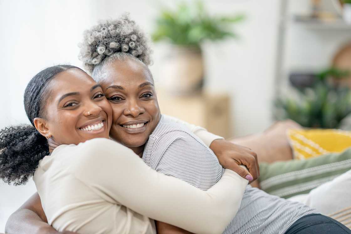 Two woemn are hugging