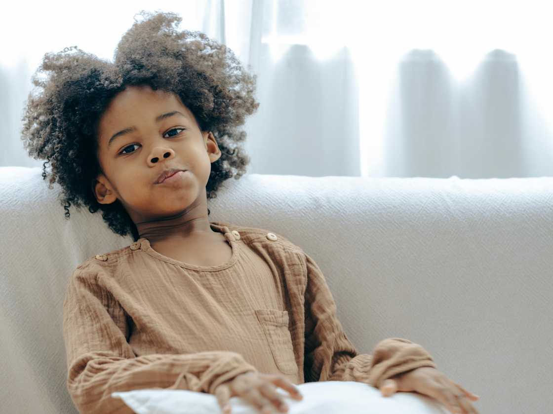 A young boy in brown clothes