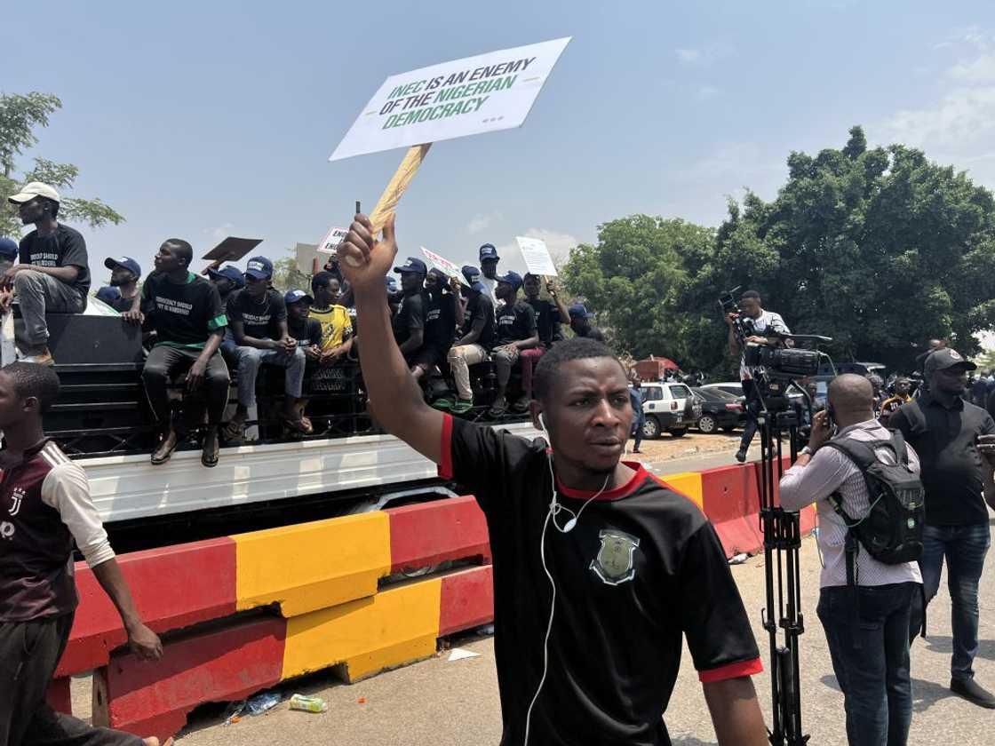 Supporters of Nigerian opposition party Peoples Democratic Party (PDP) gather outside the head of the Independent National Electoral Commission (INEC)