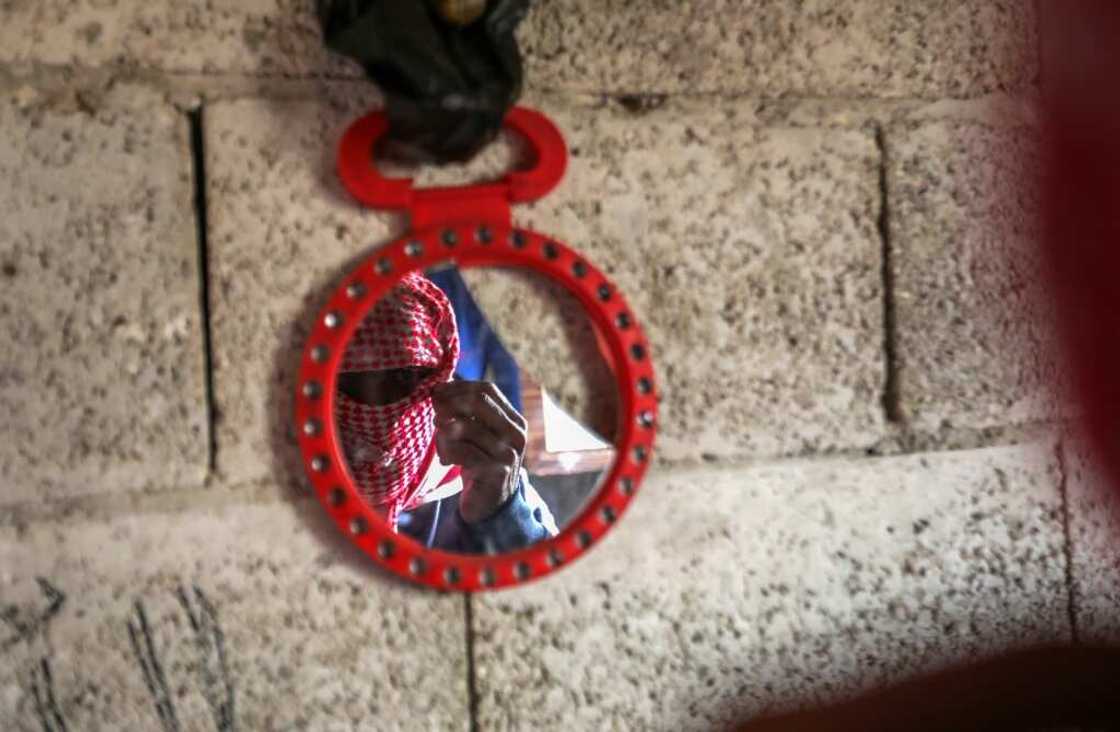 A captagon dealer masks his face with a traditional keffiyeh scarf before an AFP interview in Aleppo, Syria A captagon dealer masks his face with a traditional keffiyeh scarf before an AFP interview in Aleppo, Syria