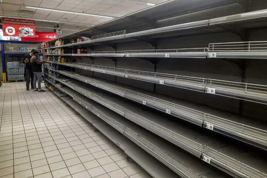Empty shelves in a supermarket alley amidst a shortage of basic products in Tunisia's capital Tunis Empty shelves in a supermarket alley amidst a shortage of basic products in Tunisia's capital Tunis