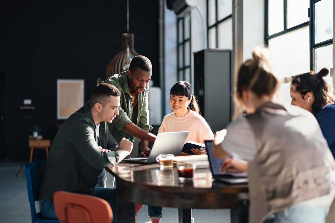 Young professionals collaborating in a bright, contemporary co-working environment