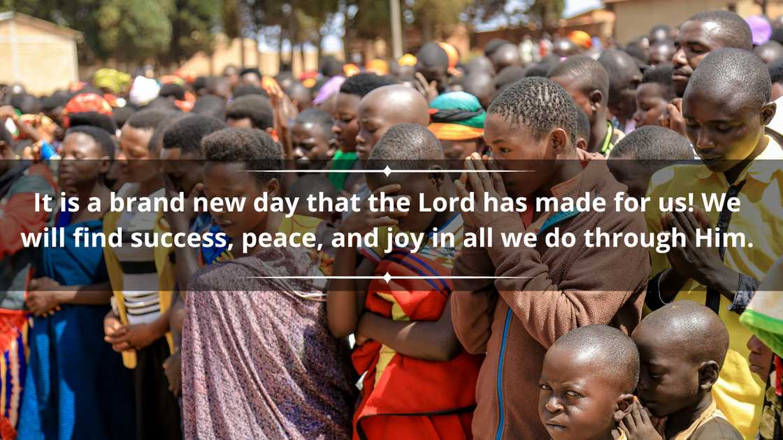 A group of children and adults is praying outdoors A group of children and adults is praying outdoors
