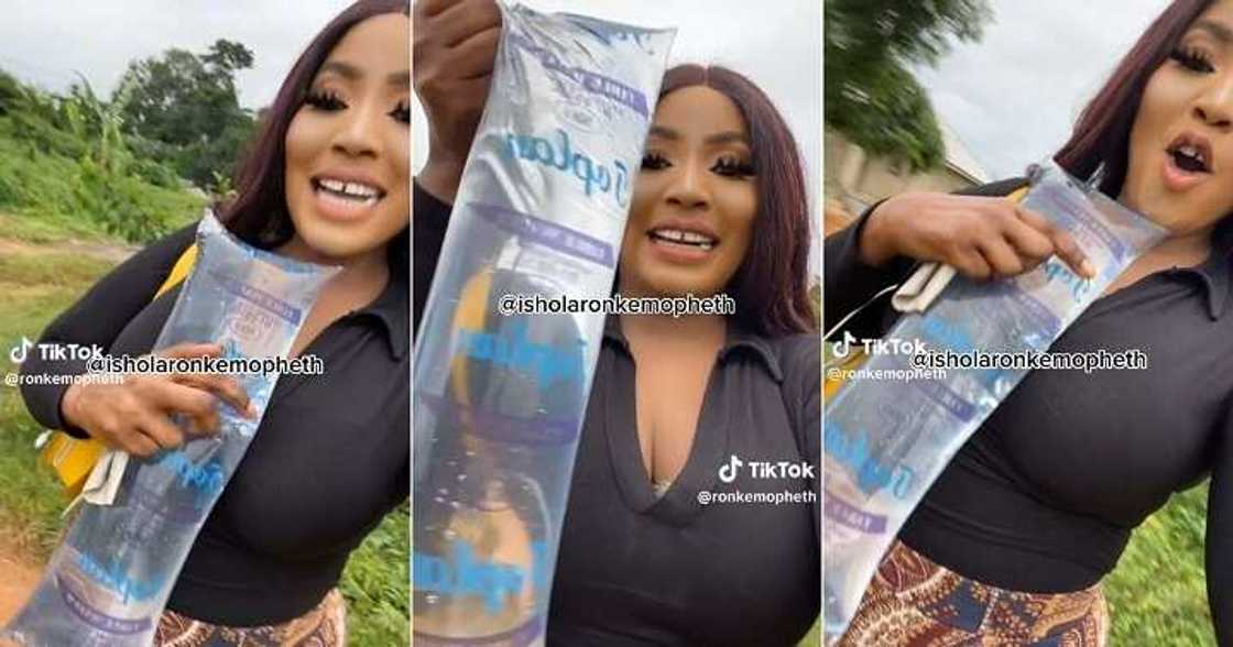 Lady buys pure water for N10 in Benin