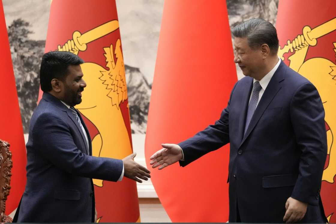 Chinese President Xi Jinping (R) shakes hands with Sri Lankan President Anura Kumara Dissanayake during a signing ceremony at the Great Hall of the People in Beijing on January 15, 2025