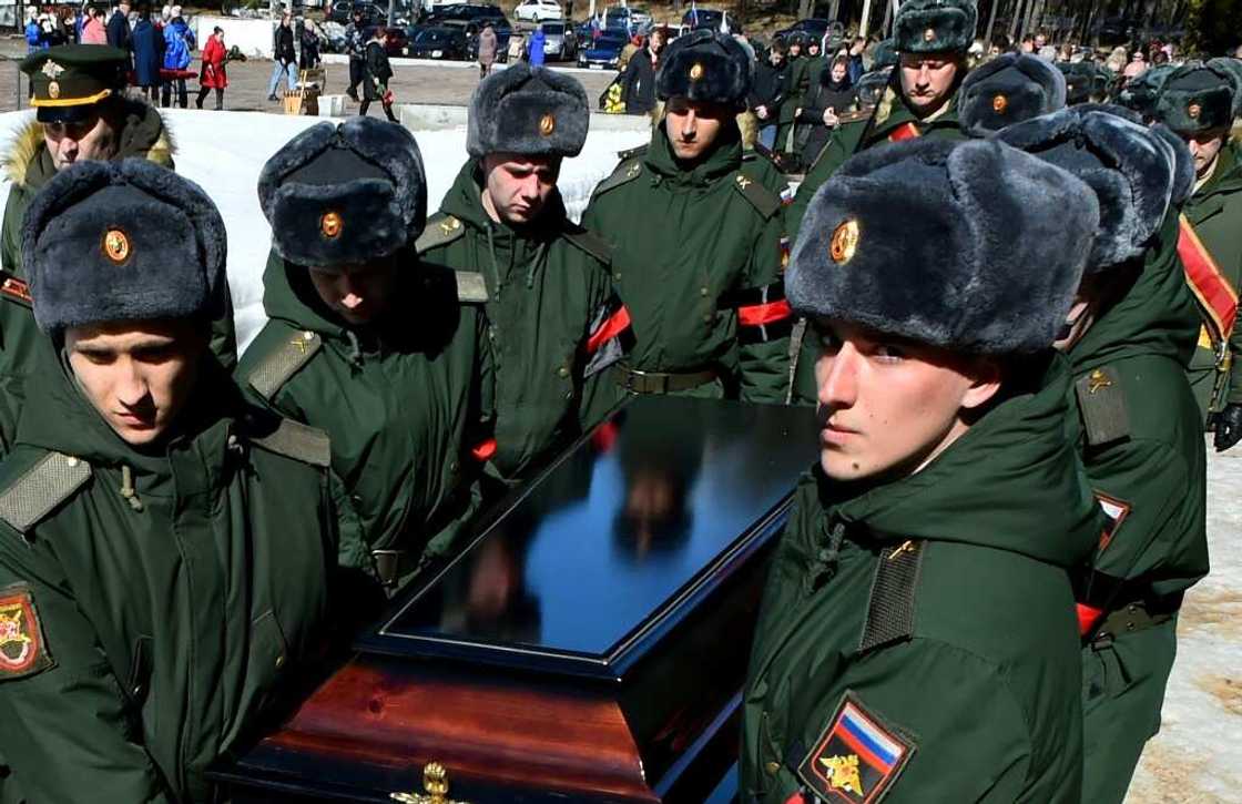 Soldiers carry the coffin of 20-year-old Russian serviceman Nikita Avrov, during his funeral at a church in Luga, some 150 kilometers south of Saint Petersburg, on April 11, 2022 Soldiers carry the coffin of 20-year-old Russian serviceman Nikita Avrov, during his funeral at a church in Luga, some 150 kilometers south of Saint Petersburg, on April 11, 2022