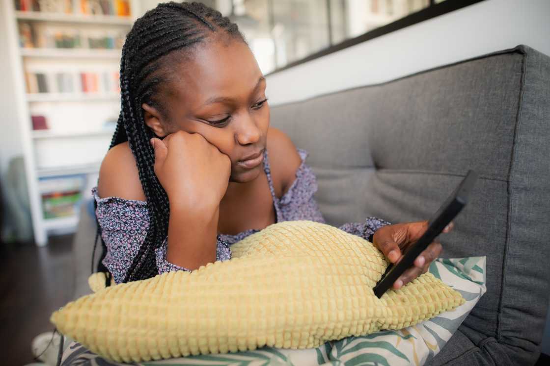 Sad young woman with a smartphone Sad young woman with a smartphone
