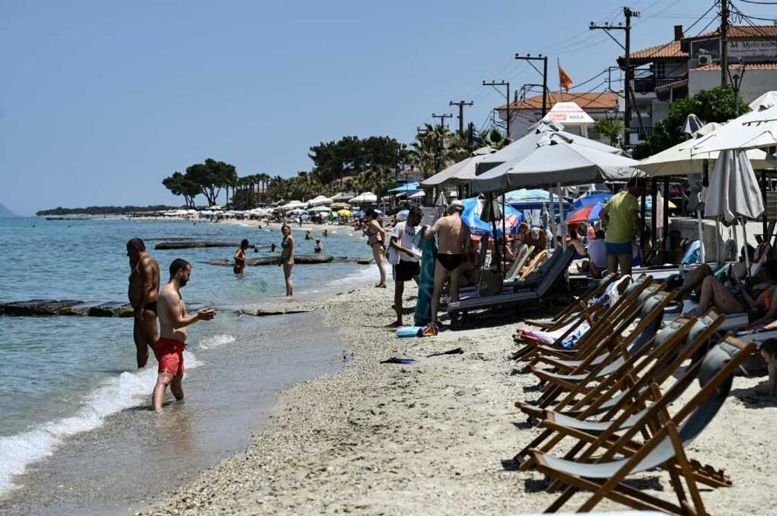 Deckchairs and sunbeds taking off almost all of a beach on the Halkidiki peninsula in northern Greece Deckchairs and sunbeds taking off almost all of a beach on the Halkidiki peninsula in northern Greece