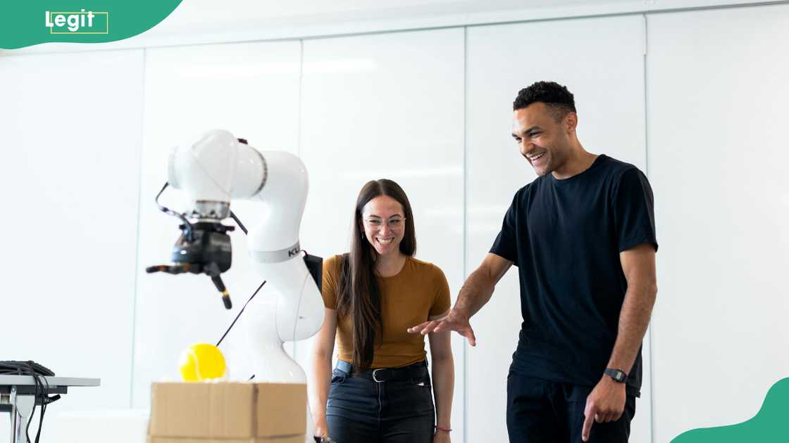 Engineers developing a robotic arm